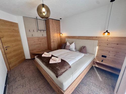 a bedroom with a bed with two towels on it at Haus Bodner in Kartitsch