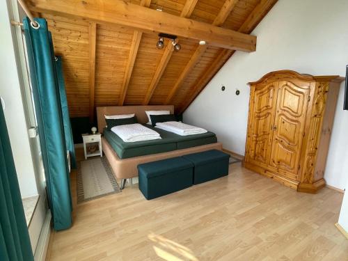 a bedroom with two beds and a wooden ceiling at Ferienwohnung Auf dem Hohen in Hüfingen