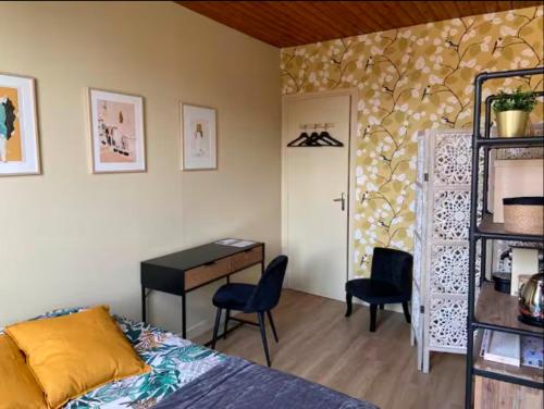 a bedroom with a bed and a desk and a table at Escales patrimoniales en cœur de ville in Poitiers