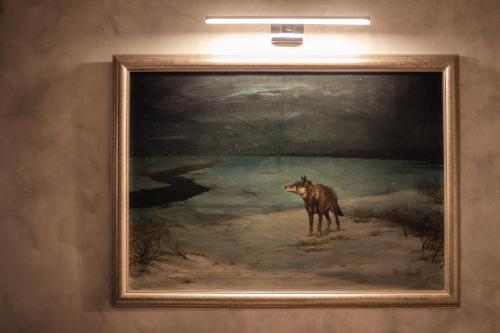 a painting of a dog in a painting on a wall at Luxury Apartments No. 91 in Český Krumlov