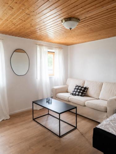a living room with a couch and a table at Villa Ralli in Jämsä