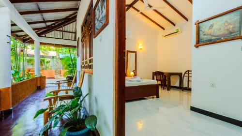 a living room with a table and a dining room at Sayare Inn in Dambulla
