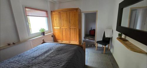 a bedroom with a bed and a cabinet and a window at Meyers FeWo - Hüddingen in Reinhardshausen