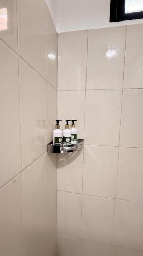 two toasters on a shelf on a white tiled wall at Secret Garden Beach Hotel in Trincomalee