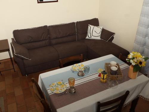 a living room with a table and a couch at PanElios Borgo Vacanze in Città della Pieve