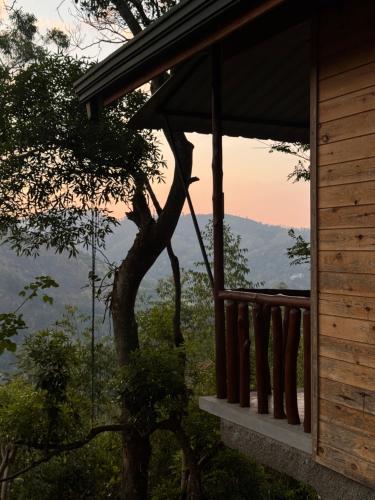 a view from the porch of a house with a tree at Saffron Eco Cottage in Ella