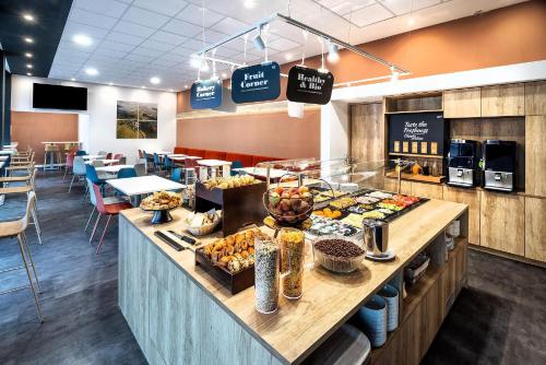 a bakery with a buffet of food on a counter at B&B HOTEL Maribor Orel in Maribor
