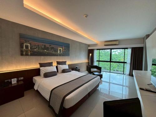 a bedroom with a large bed and a desk in it at Nine Forty One Hotel in Bangkok