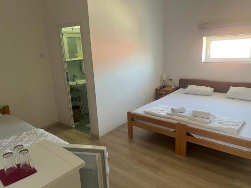 a small room with a bed and a mirror at Tabacco in Obrenovac