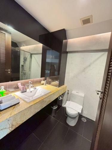 a bathroom with a sink and a toilet at Nine Forty One Hotel in Bangkok