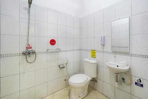 a bathroom with a toilet and a sink at RedDoorz Plus near Universitas Maranatha Bandung 2 in Bandung