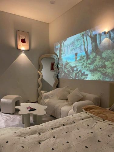 a bedroom with a bed and a painting on the wall at Bảo Châm Homestay in Gia Lâm Pho