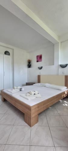 a large bed in a white room with at Hrstich Apartments in Drasnice