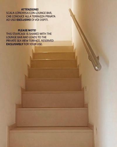 a staircase with a stair railing with a quote on the wall at Bella Vista Grotta Ardito in Polignano a Mare