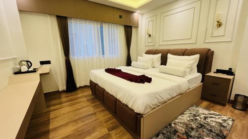 a bedroom with a large bed in a room at Aabuu Babuu Resort & Banquet in Kurseong