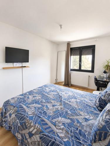 a bedroom with a bed and a tv on the wall at Beautiful, modern room in Saint-Paul-de-Varax