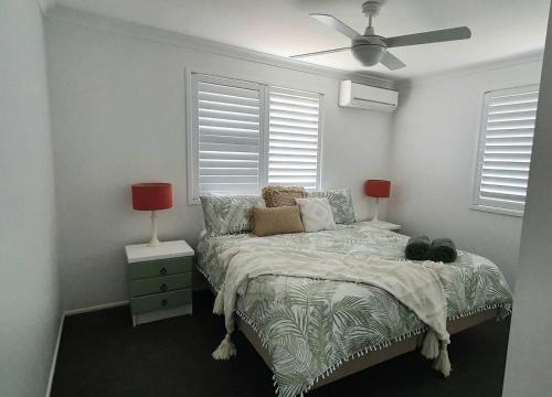 a bedroom with a bed and a ceiling fan at Marigold House in Rockville