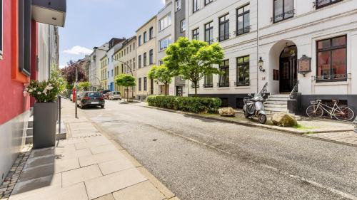 an empty street in a city with buildings at STACEY Alster in Hamburg