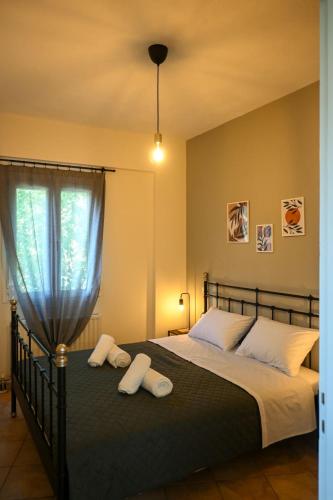 a bedroom with a bed with two towels on it at Sunset Stories Apartments in Konitsa