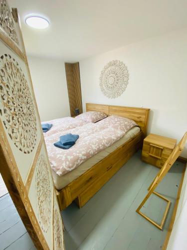 a bedroom with a wooden bed and a mirror at Familien-Ferienhaus am Felsenlabyrinth in Bad Gottleuba