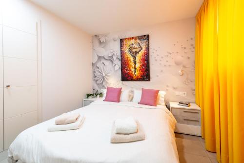 a bedroom with a large white bed with pink pillows at Luxurious Two Bed in Torrox