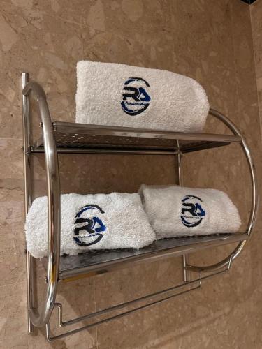 a towel rack with white towels on it at RAFURADOURO in Ovar