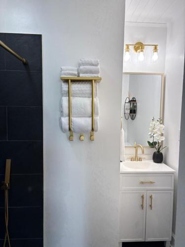 a bathroom with a sink and a mirror and towels at Tranquil Suite Studio in Wilson