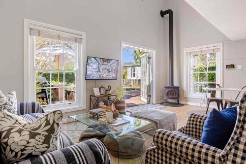 a living room with two couches and a fireplace at Magnolia Cottage in Cape Town