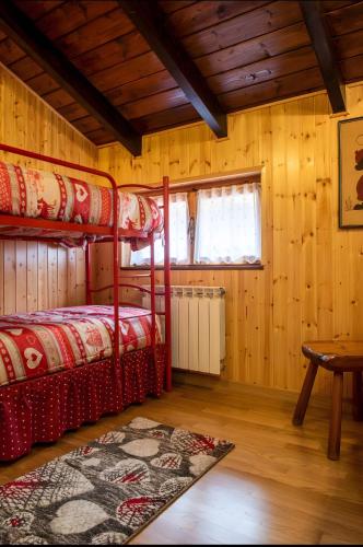 a bedroom with two bunk beds and a table at Heidi Montelivata in Subiaco