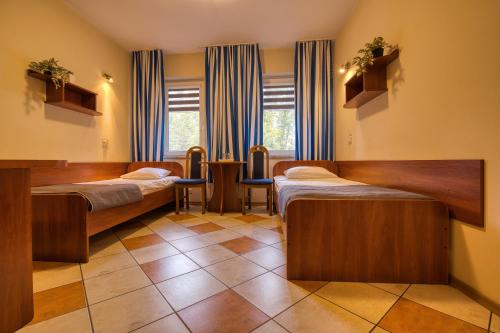 a hospital room with three beds in it at Gościniec pod Żaglami in Skoki Duże