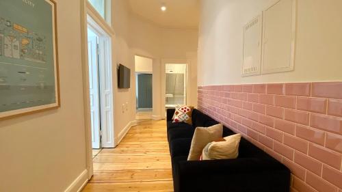 a living room with a couch and a brick wall at STACEY Downtown in Hamburg