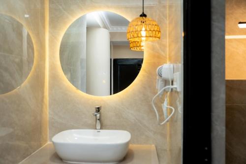 a bathroom with a sink and a mirror at Boudha Mandala Hotel in Kathmandu