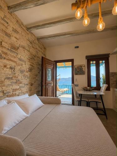 a bedroom with a large bed and a table at Miloa Klima View 'Syrma' in Klima