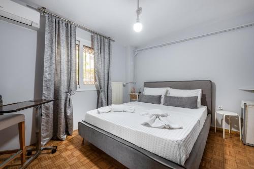 a bedroom with a large bed and a window at Amarysia Residence in Athens