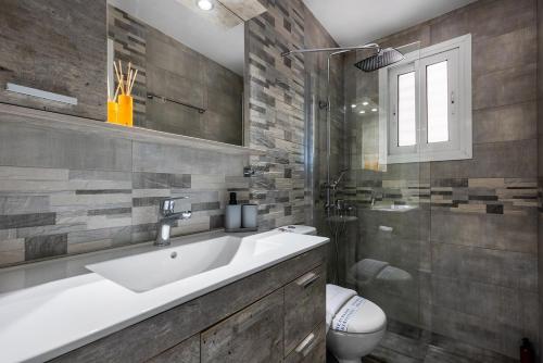 a bathroom with a sink and a toilet and a shower at Amarysia Residence in Athens