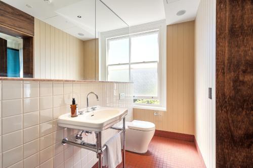 a bathroom with a sink and a toilet at Mercantile Hotel in Sydney