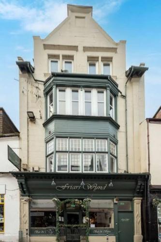 a large building with a store in front of it at Friars Wynd Guest Rooms in Stirling