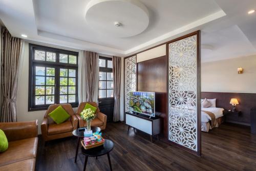 a hotel room with a bed and a living room at Lacasa Sapa Hotel in Sapa