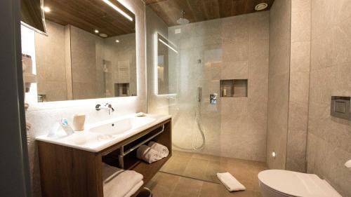 a bathroom with a sink and a shower and a toilet at TH Courmayeur in Courmayeur