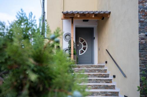 a stairway leading up to a grey door at Casa Maria-Anneta in Kalives Poligirou