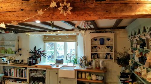 a kitchen with a sink and a window at Tracebridge Cottage B&B in Stawley