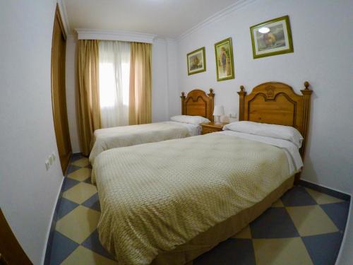 Posteľ alebo postele v izbe v ubytovaní Apartamentos Niña de Oro
