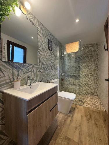 a bathroom with a sink and a toilet at Apartamentos Rurales La Estrella in Casar de Palomero