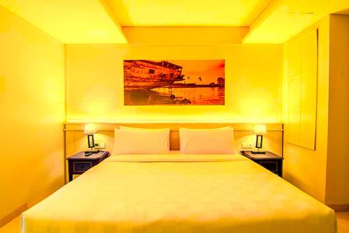 a bedroom with a large bed with two night stands at Hotel Radhakunj Inn in Dhanbād