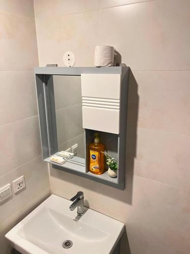 a bathroom with a sink with a mirror and a sink at Sky residences in Lahore