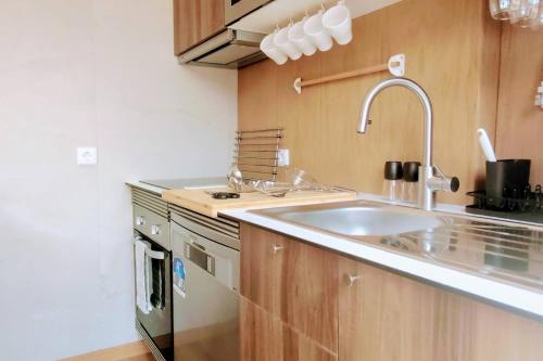 a kitchen with a sink and a stove at Lisbon, beach, city & surf in Trafaria