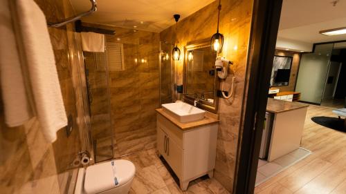a bathroom with a toilet and a sink and a shower at Mas Suites Nisantasi in Istanbul
