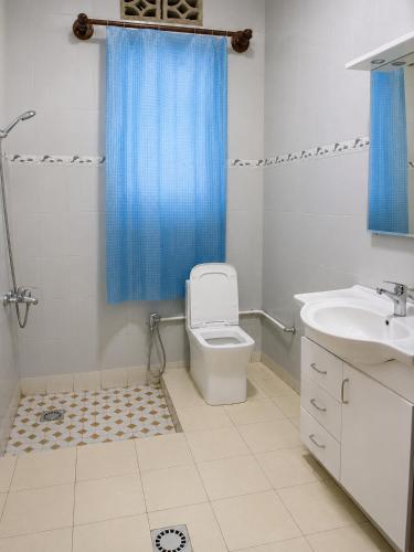 a bathroom with a toilet and a sink and a shower at The Gathering in Kigali