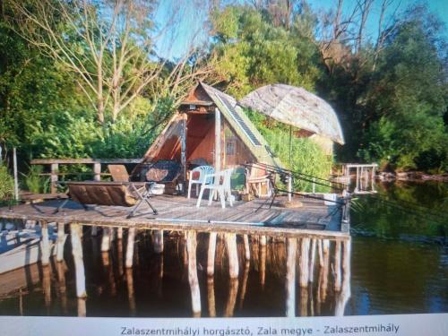 a yurt on a dock on a body of water at Diviák Apartman in Zalaszentmihály