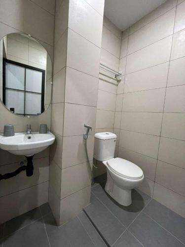 a bathroom with a toilet and a sink at Houi Hotel in Jodoh
